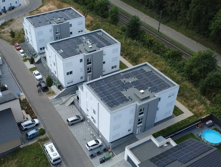 Wohnanlage mit angrenzender Bahnstrecke und Grünfläche